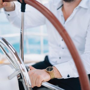 hands-man-white-shirt-sitting-helm-yacht-sailing-middle-sea-closeup
